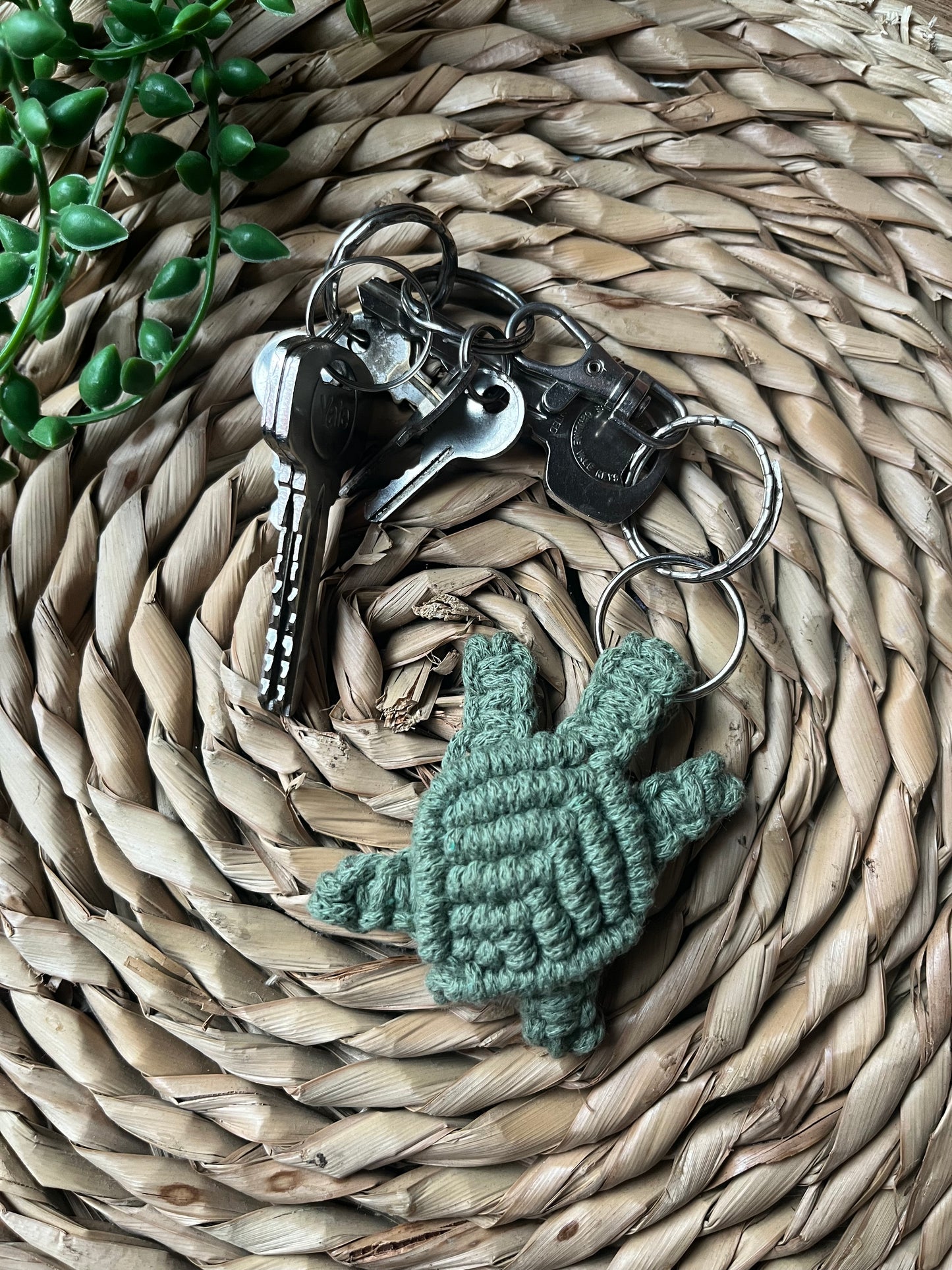 A turtle shaped macrame knotted keyring made from recycled cotton yarn.