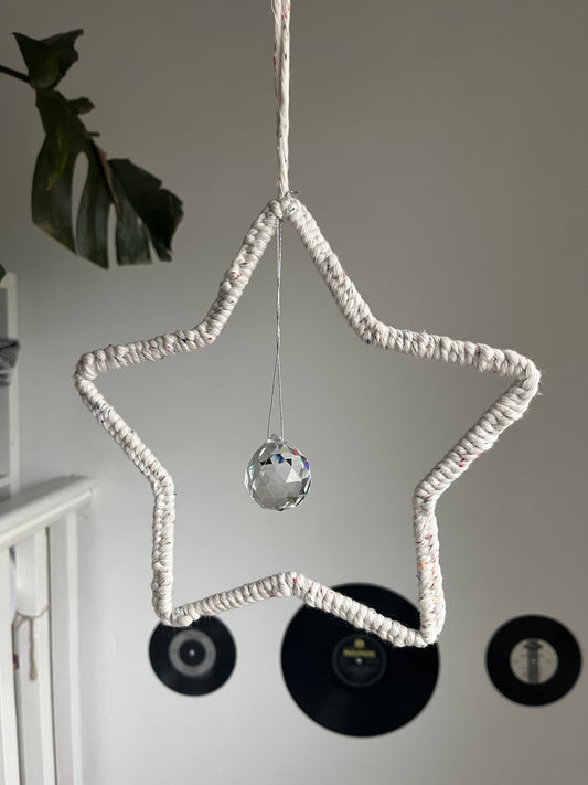 Star shaped macrame sun catcher hanging with a crystal prism. Made with recycled cotton yarn.