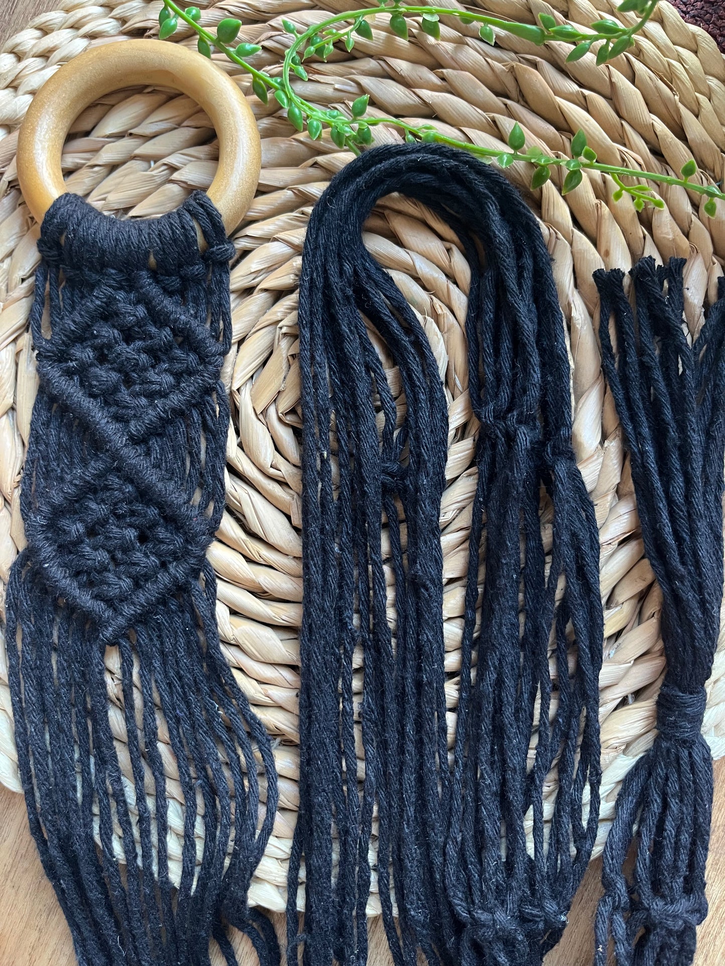 Mini sitar instrument wall hanger. Handmade using black recycled cotton on a repurposed wooden hanging ring.