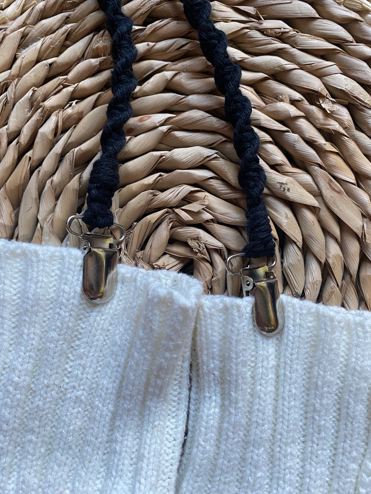 Long mitten clips for adults made with recycled cotton yarn, with metal clasps on each end. Attached to a pair of white mittens.