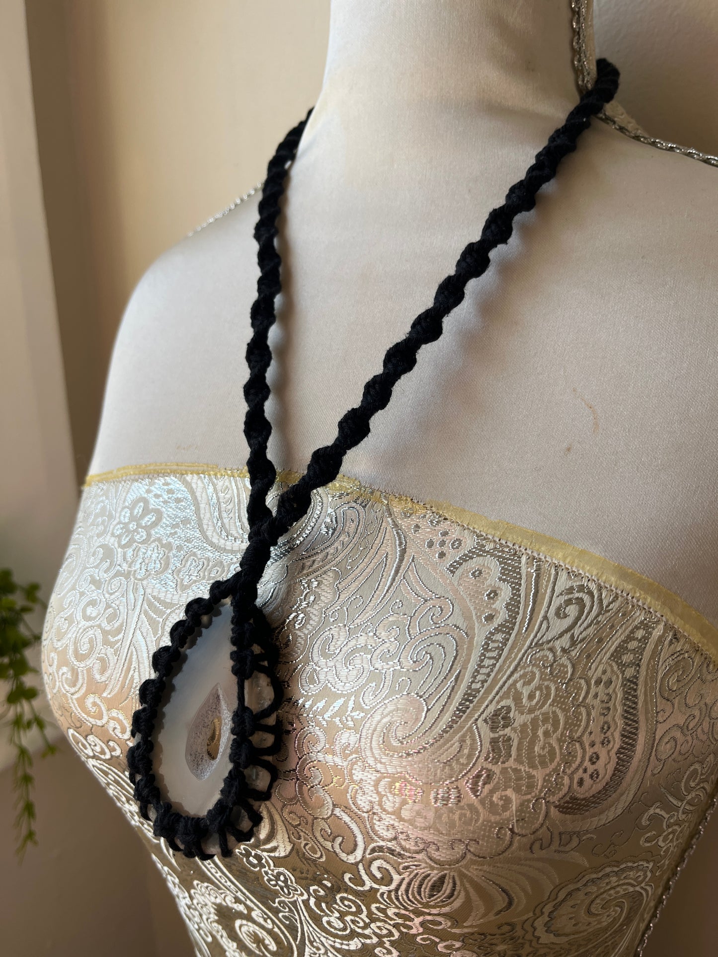 Black necklace with natural agate slice on mannequin