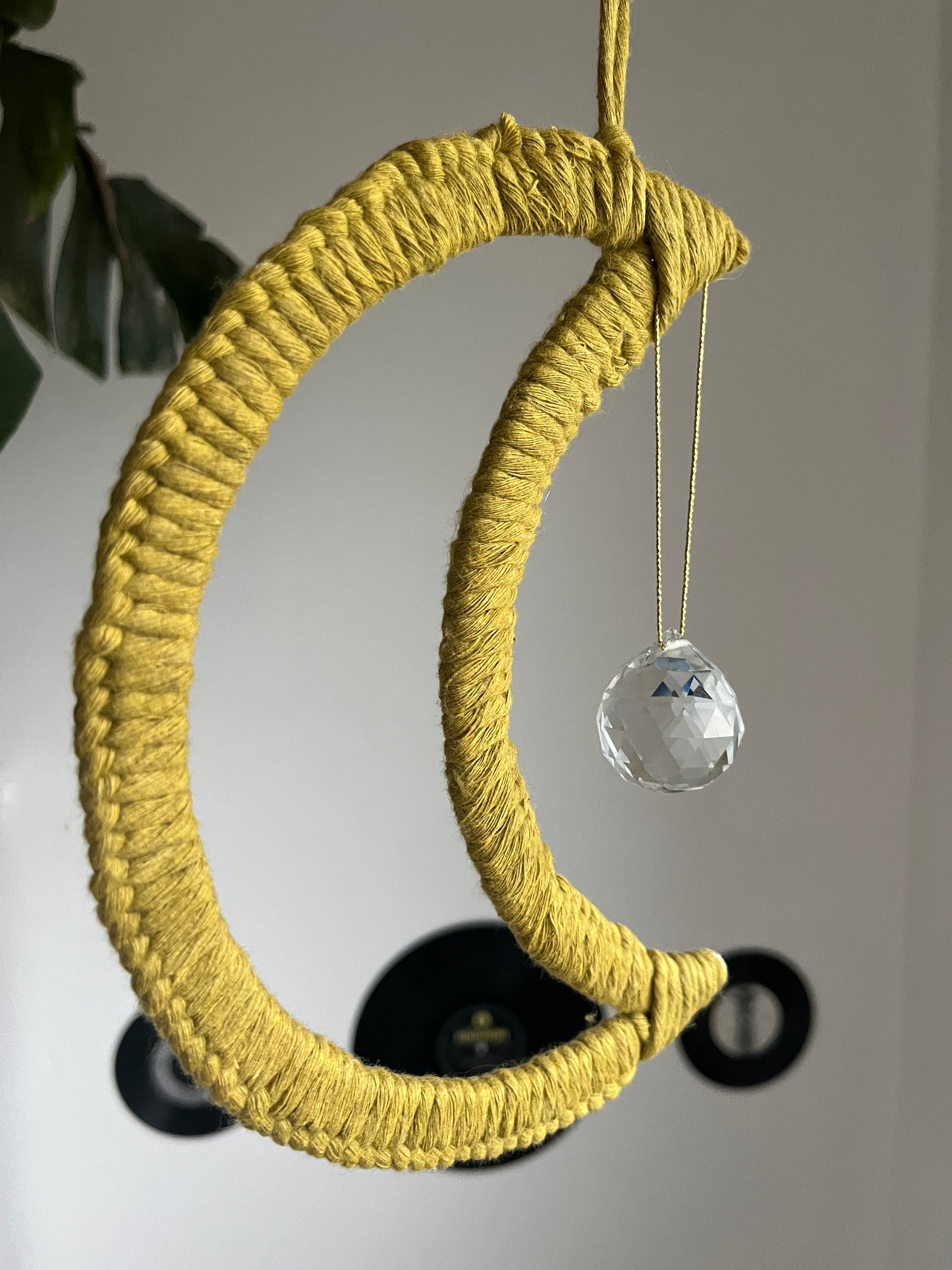 Moon shaped macrame hanging sun catcher decoration with a crystal prism