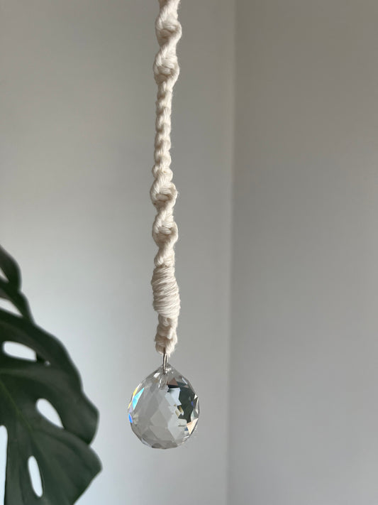 Macrame hanging sun catcher decoration with a crystal prism, made with natural coloured recycled cotton