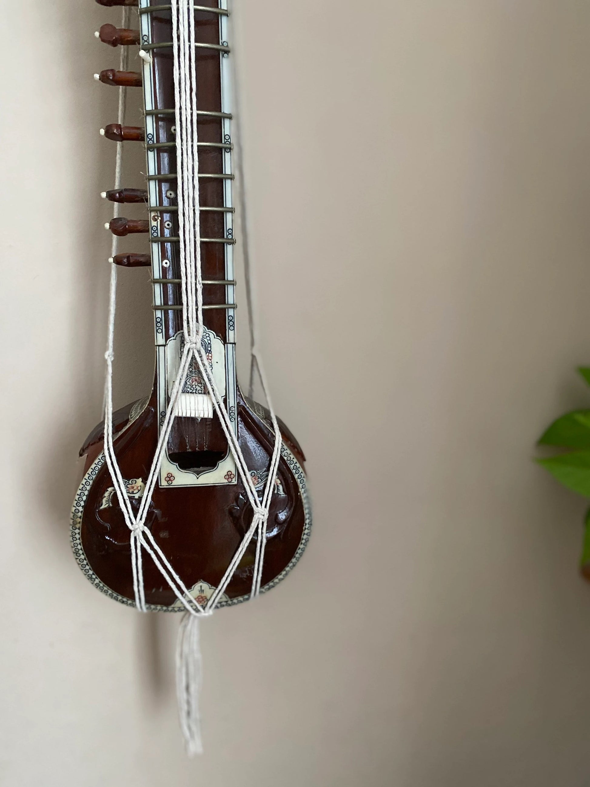 Mini sitar instrument wall hanger. Handmade using natural recycled cotton on a repurposed wooden hanging ring.