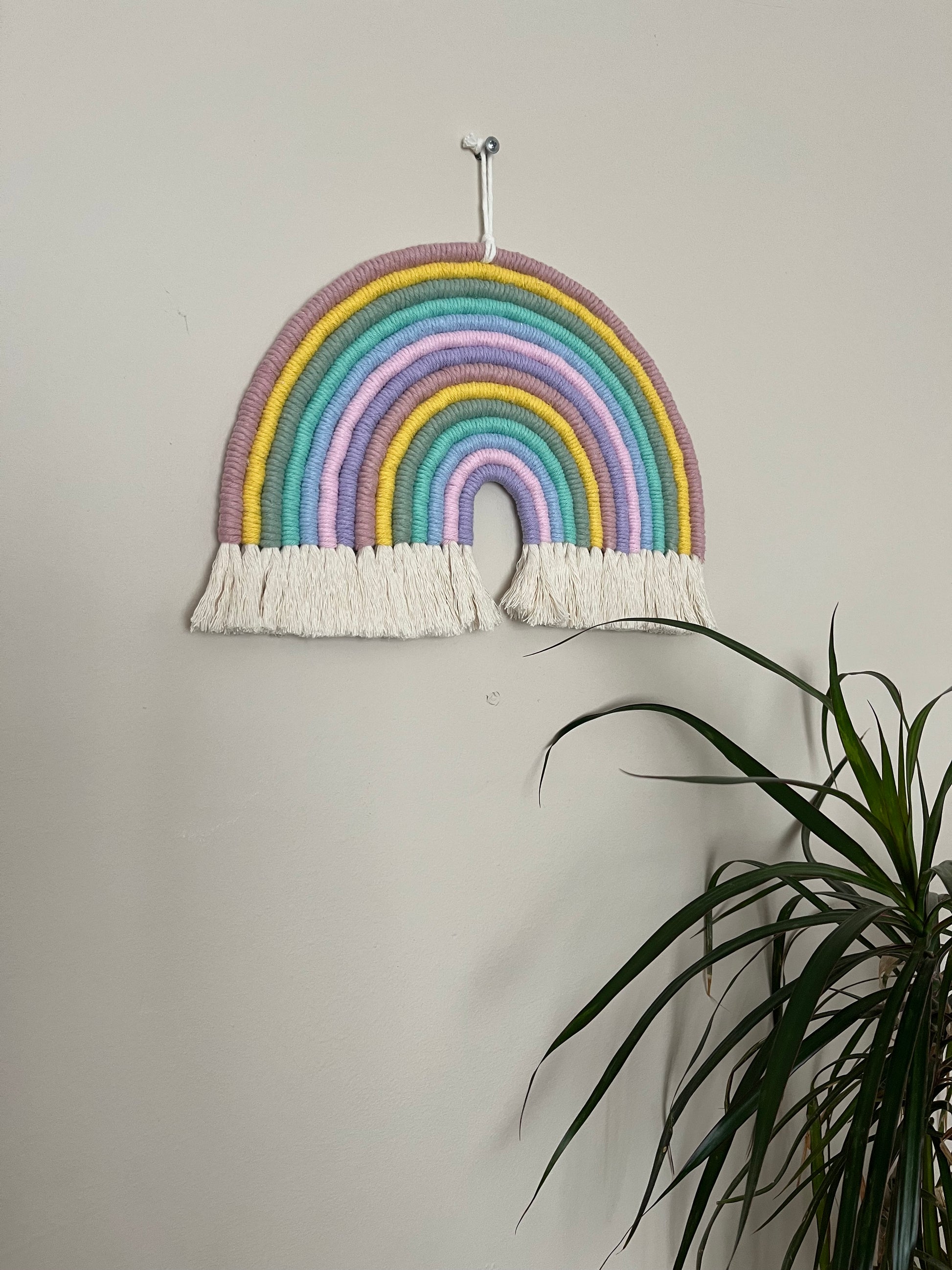 Handmade macrame wall hanging rainbow decoration made with recycled cotton
