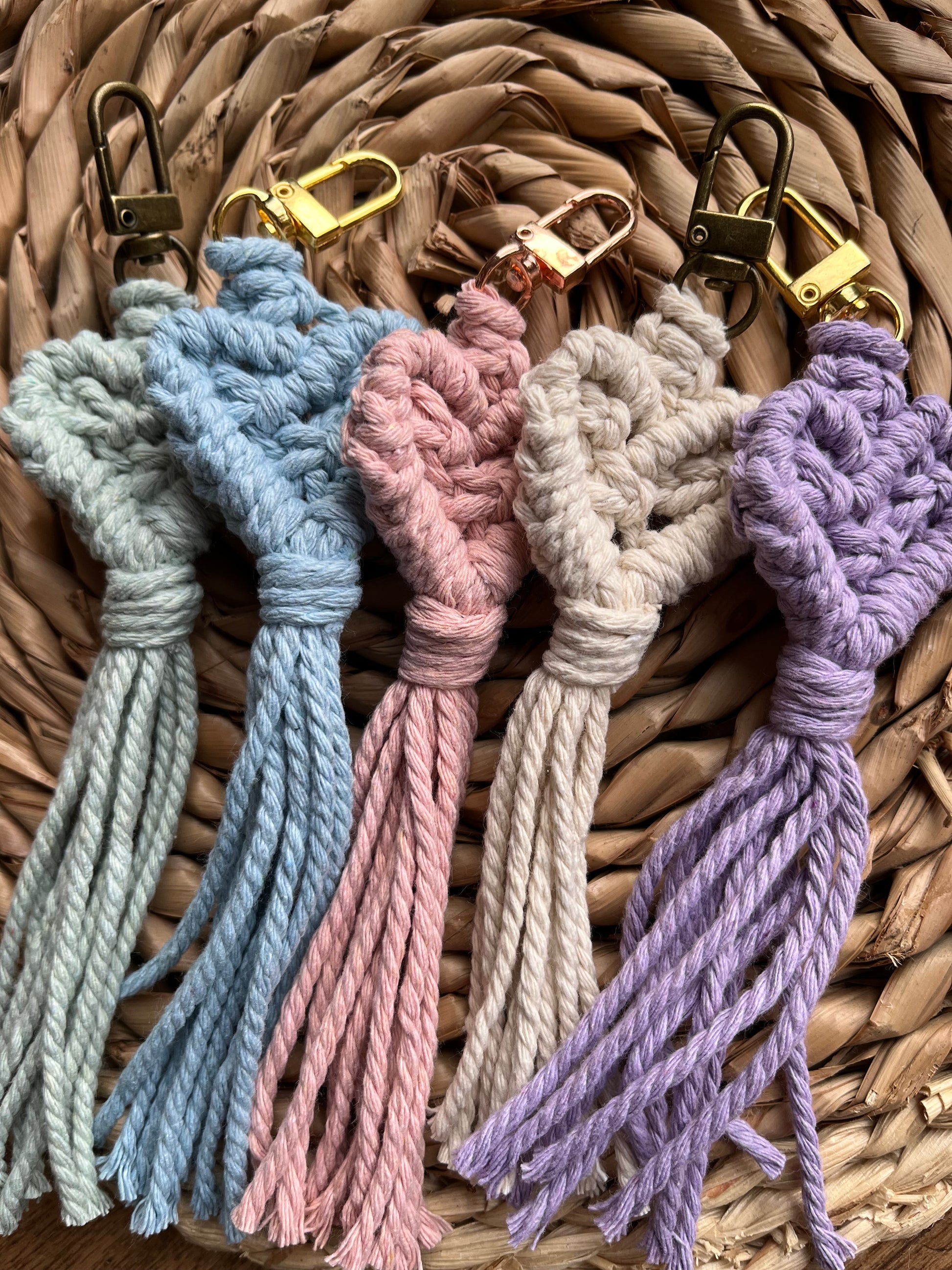 Handmade macrame heart shaped keychains made with recycled cotton in pastel shades.