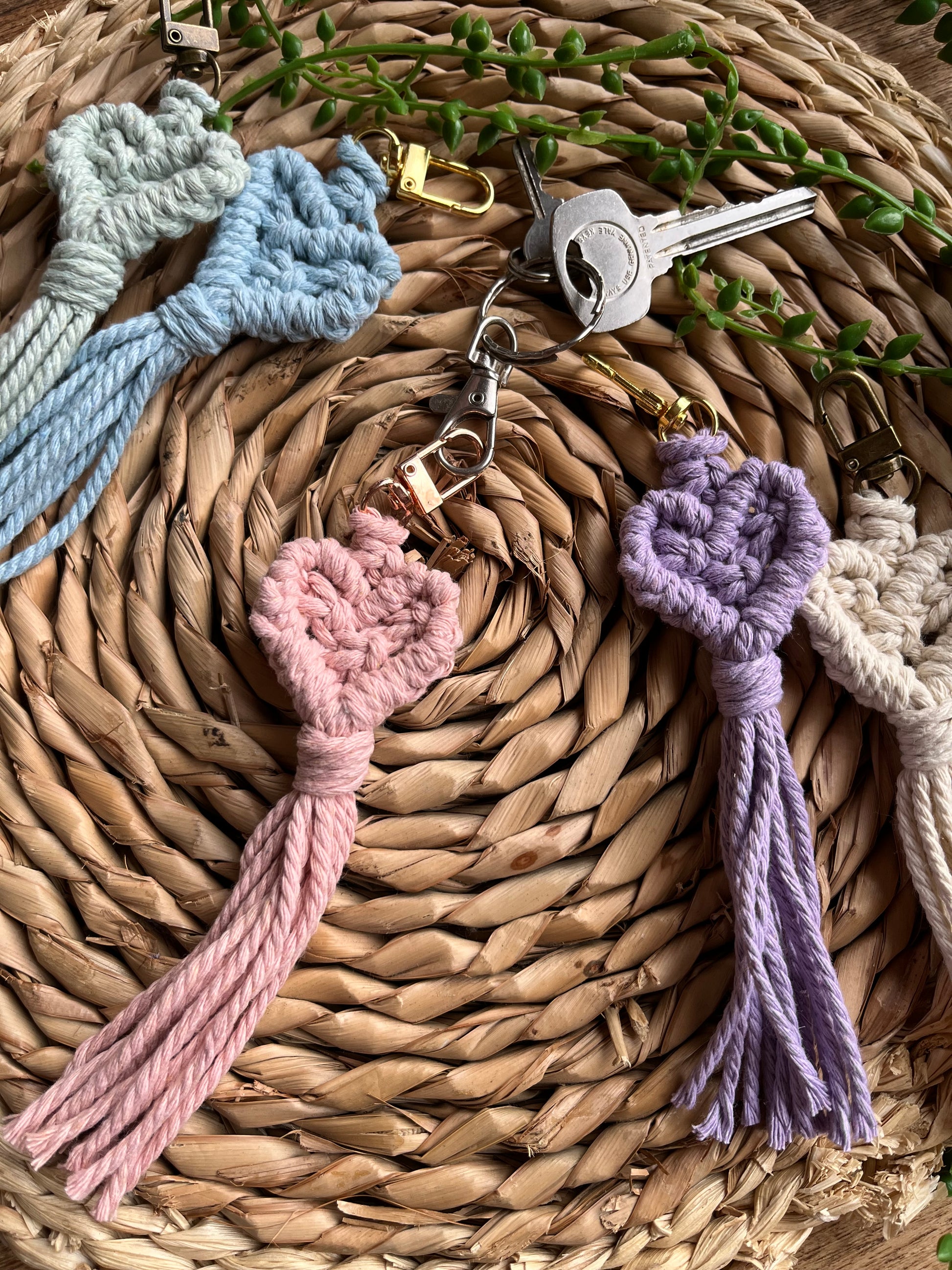Handmade macrame heart shaped keychains, made with recycled cotton in various pastel shades.