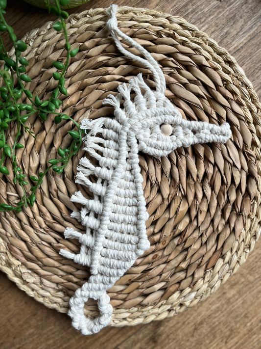 Macrame Seahorse shaped wall hanging decoration, handmade using natural recycled cotton yarn, and a small Woden bead.