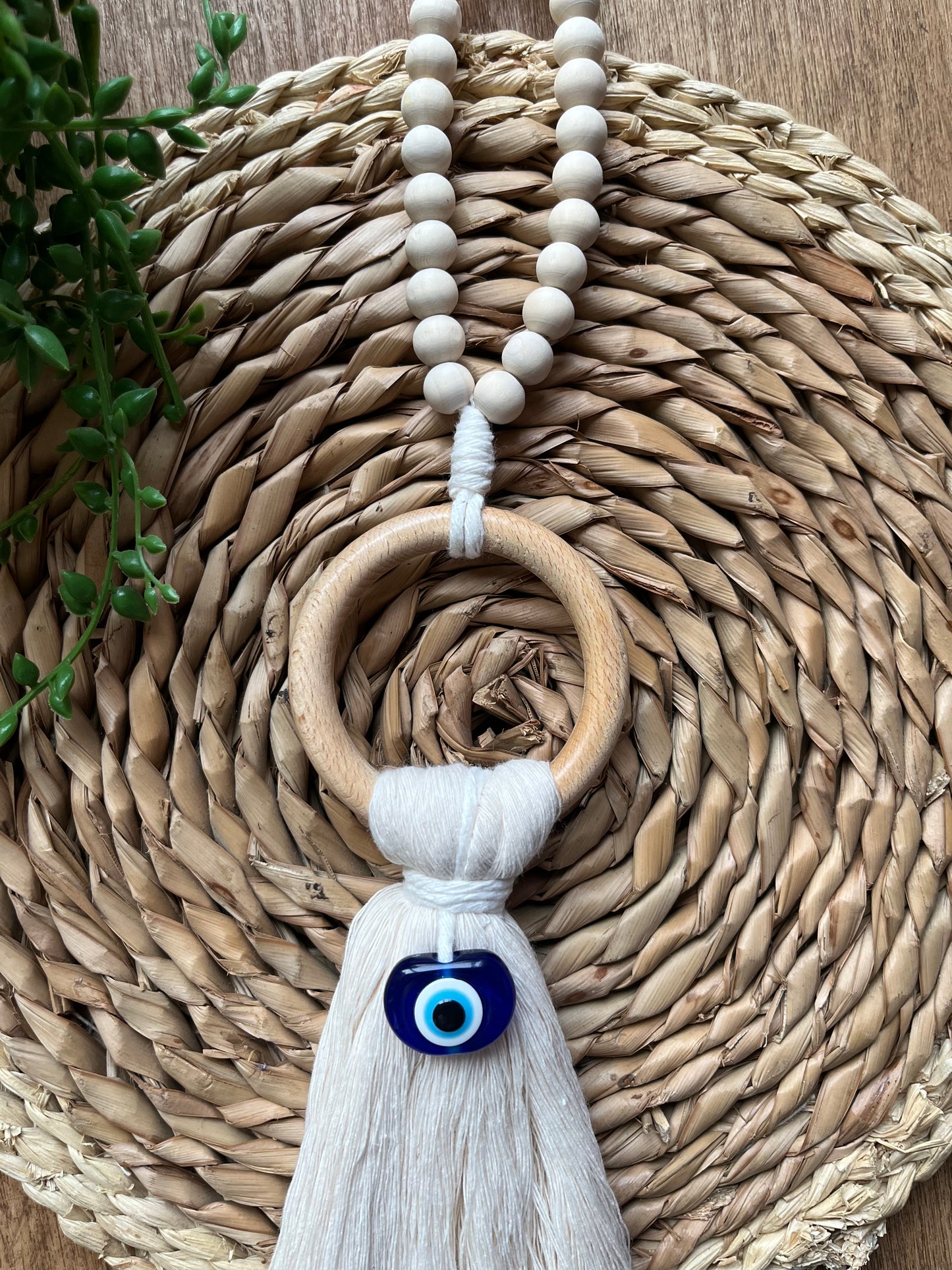 Natural coloured door hanger with evil eye bead, and wooden bead hanging loop. Made with recycled cotton yarn.