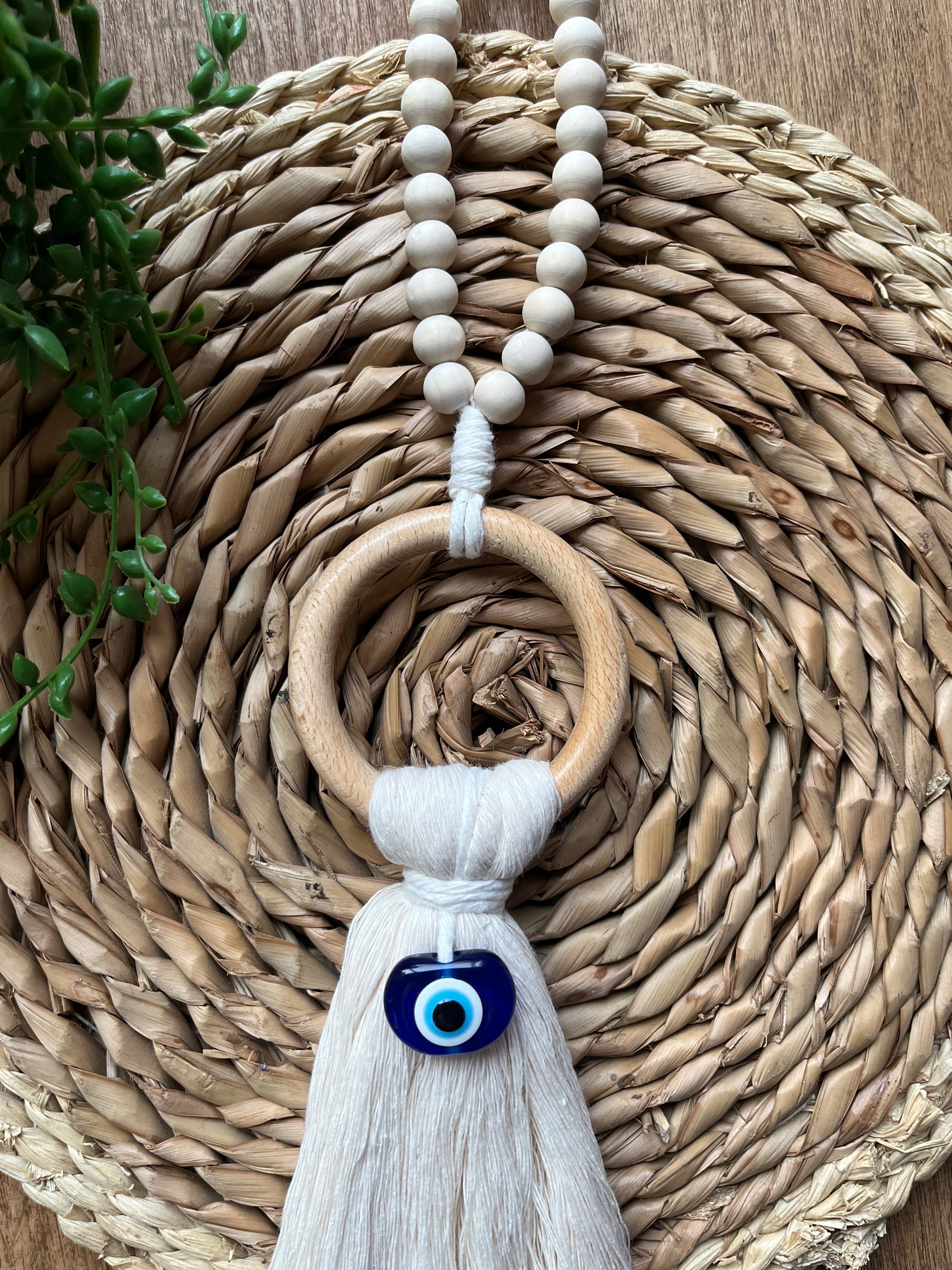 Natural coloured door hanger with evil eye bead, and wooden bead hanging loop. Made with recycled cotton yarn.
