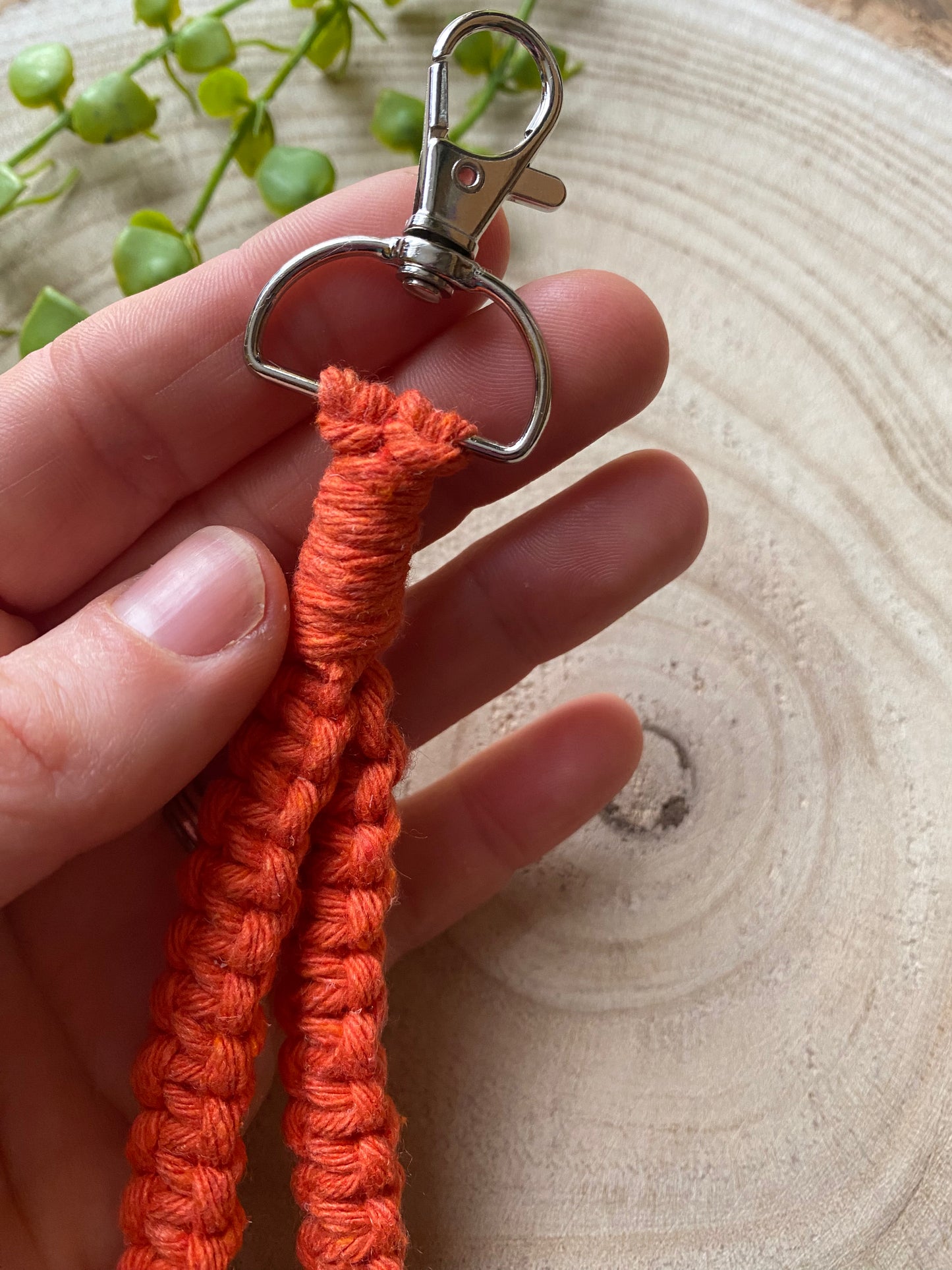 Macra-Made With Love wristlet keychain orange clasp in hand