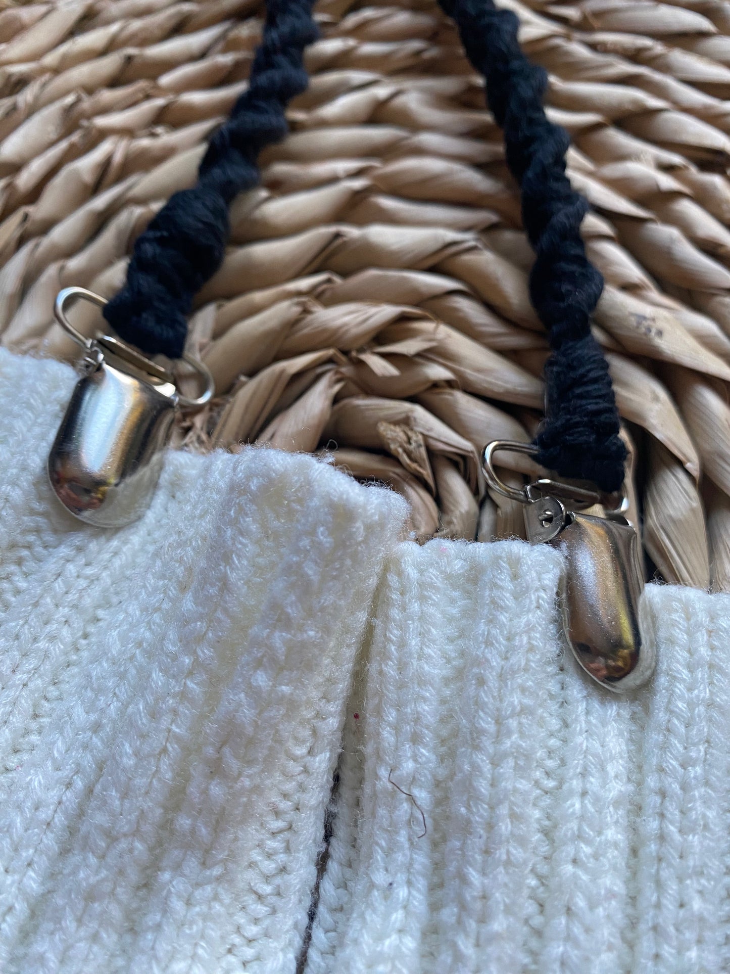 Close-up of secure metal clasps on black eco-friendly long mitten clips, attached to white mittens - handmade with recycled materials by Macra-Made With Love