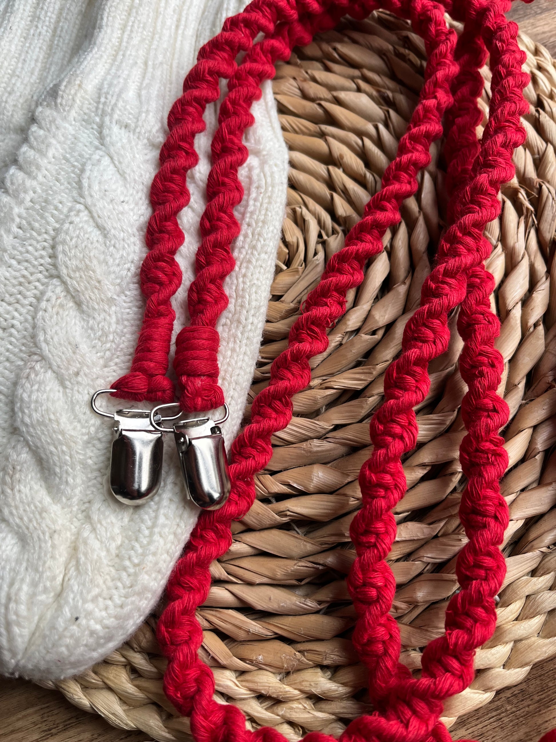 Angled close-up of bright red eco-friendly long mitten clips - showing texture and detail of handmade sustainable winter accessory