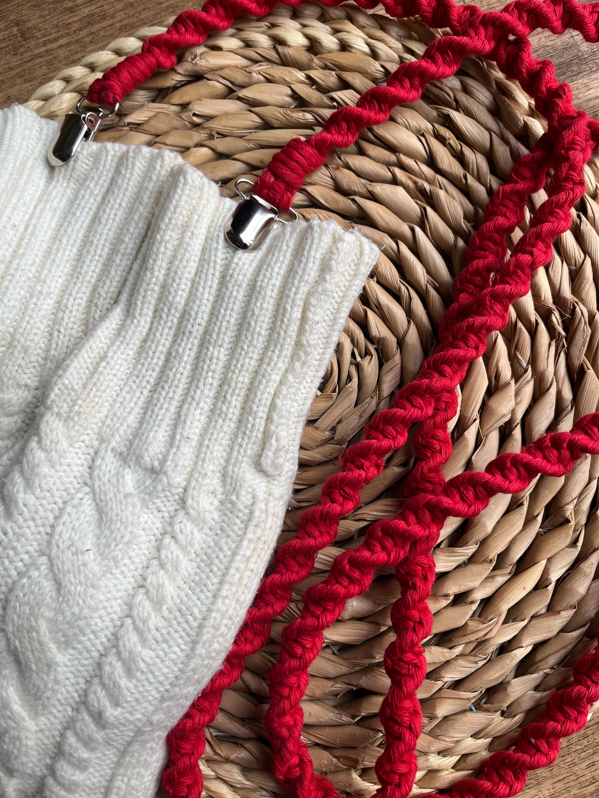 Angled close-up of bright red eco-friendly long mitten clips - showing texture and detail of handmade sustainable winter accessory