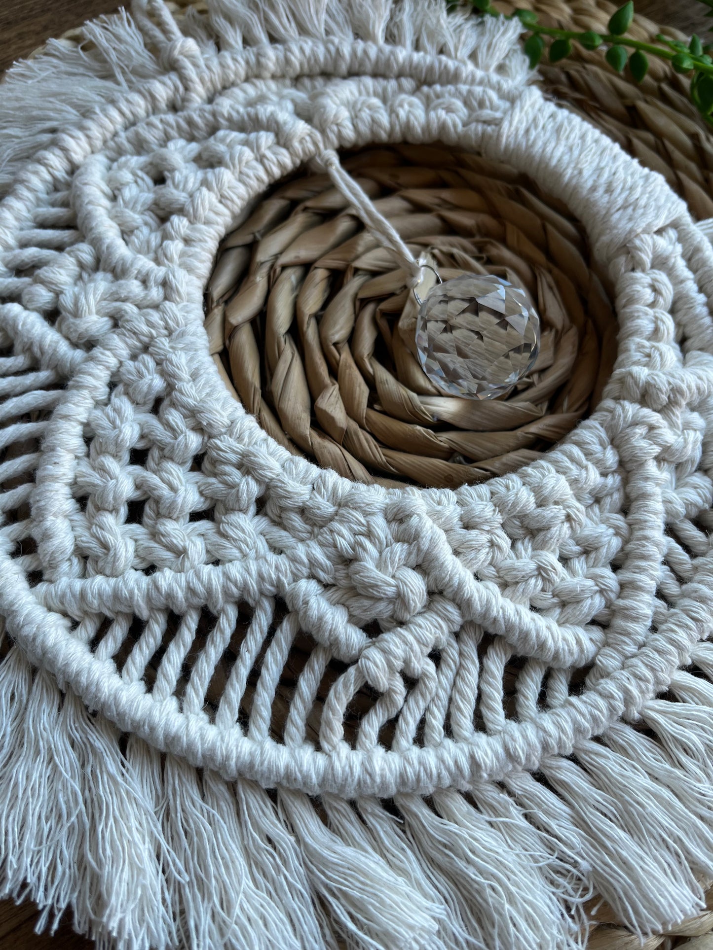 Handmade macrame moon shaped boho sun catcher made with recycled cotton natural yarn and a crystal prism in the centre.