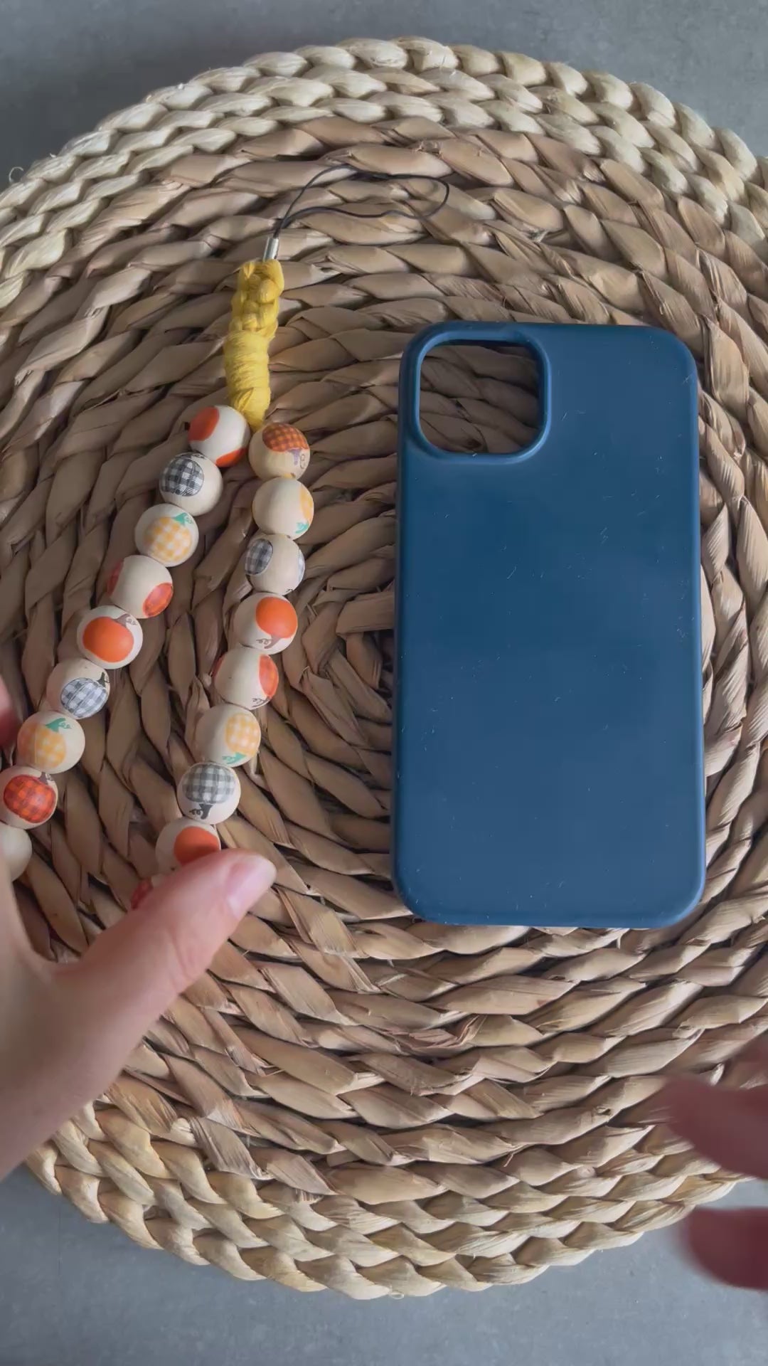 A video demonstrating how to attach a pumpkin bead phone charm on to your phone case.