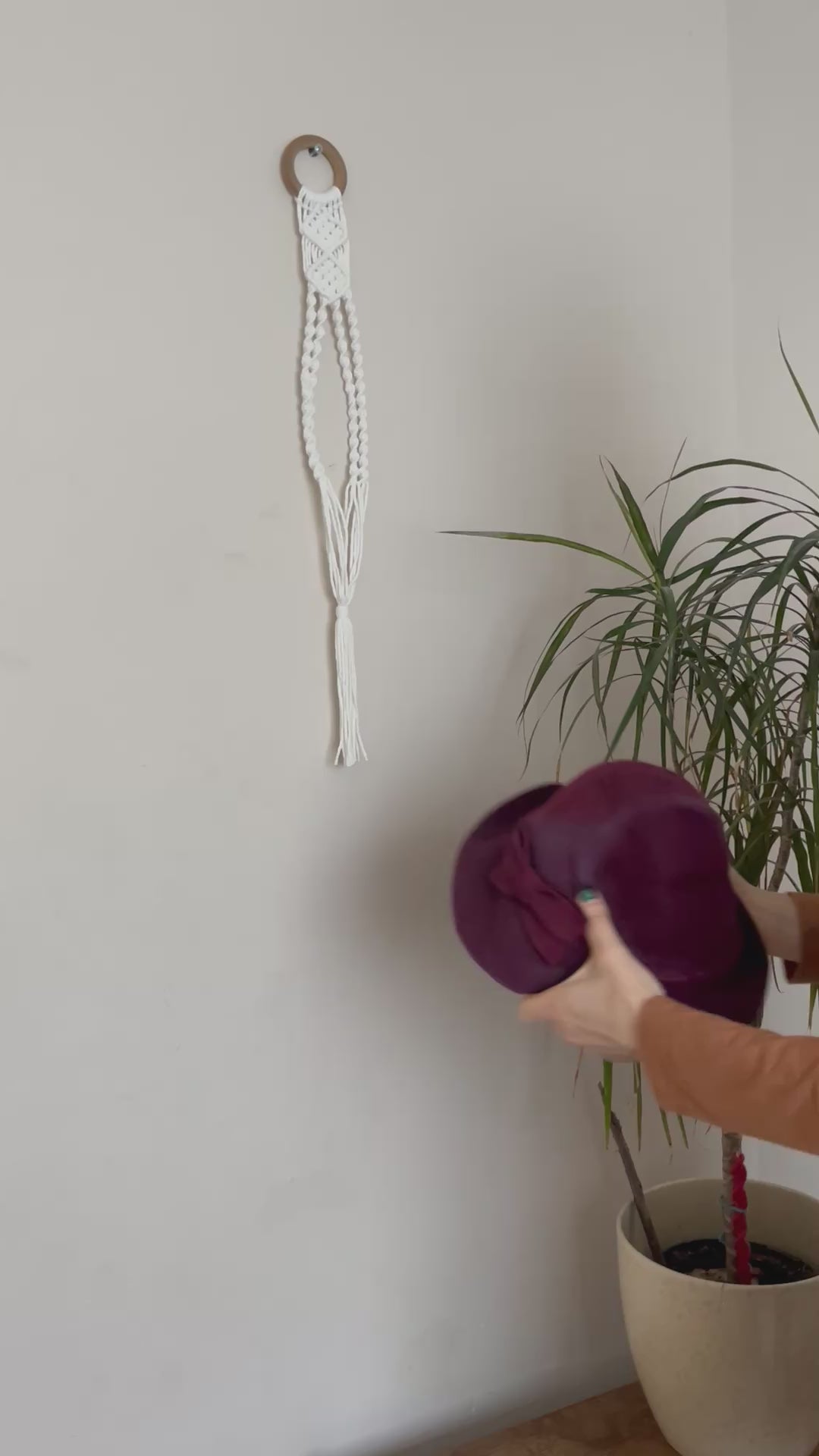 A video demonstrating how to put your hat inside a macrame wall hanging hat holder