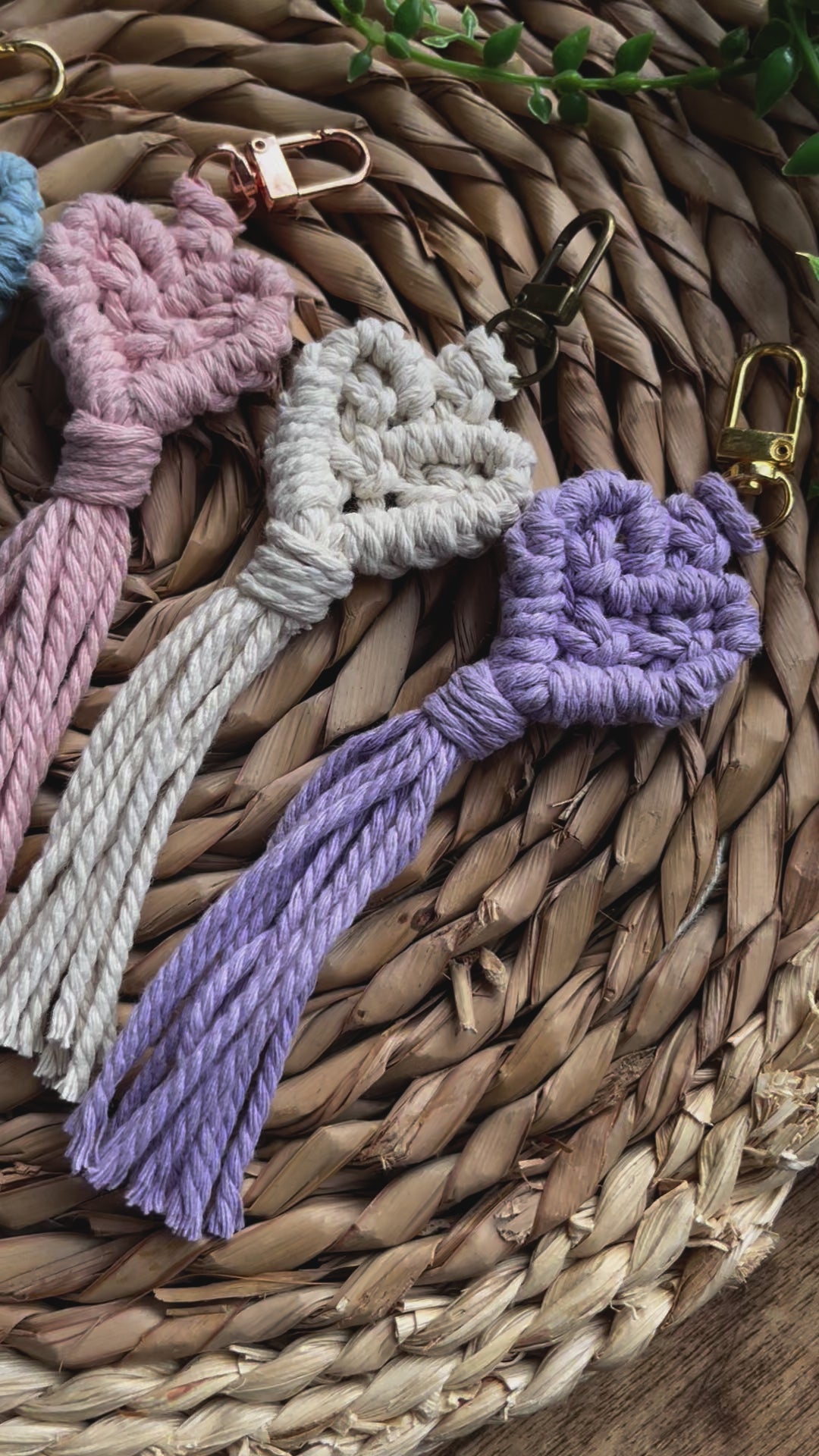 Video showing details of five handmade macrame heart shaped keychains.
