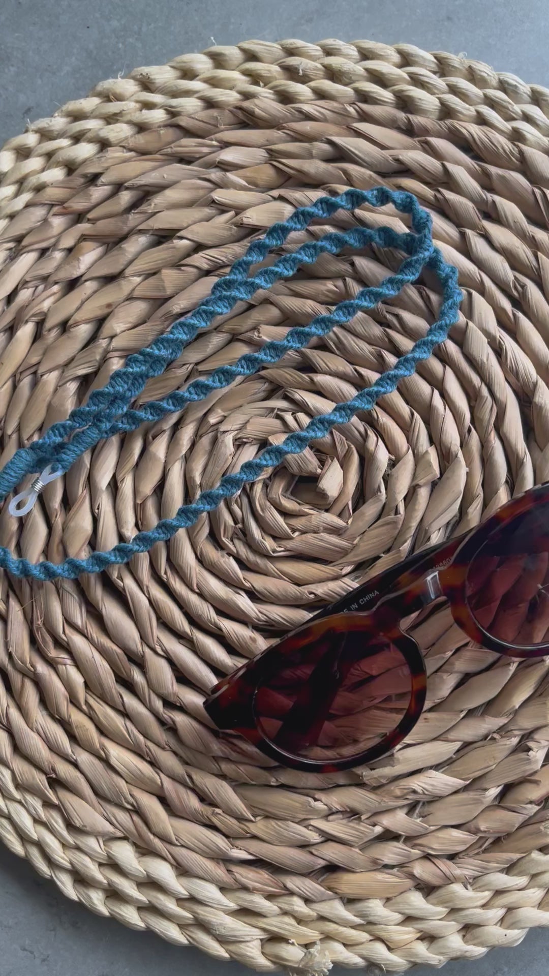 A video showing a handmade macrame eyewear holder chain, made with  recycled cotton yarn.