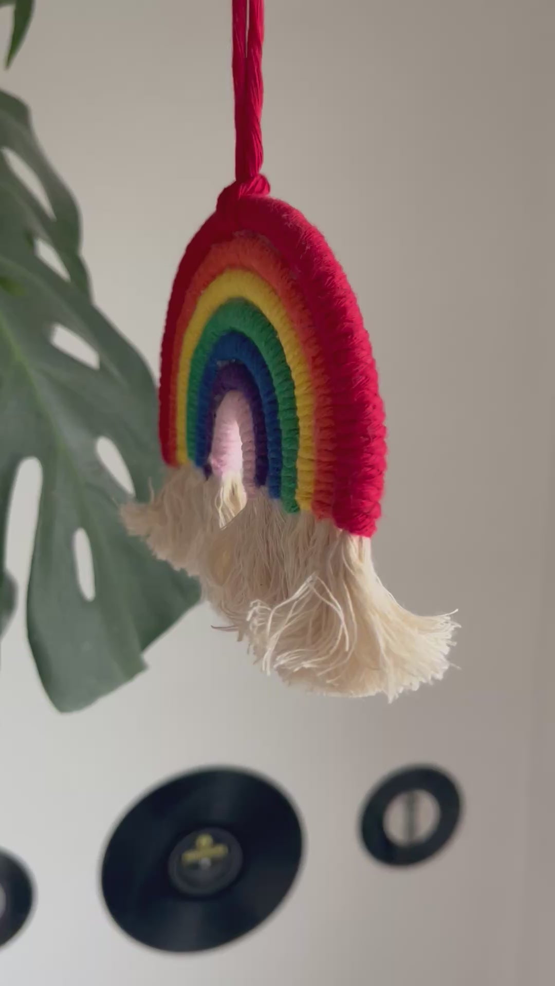 A video showing a macrame hanging rainbow in movement.