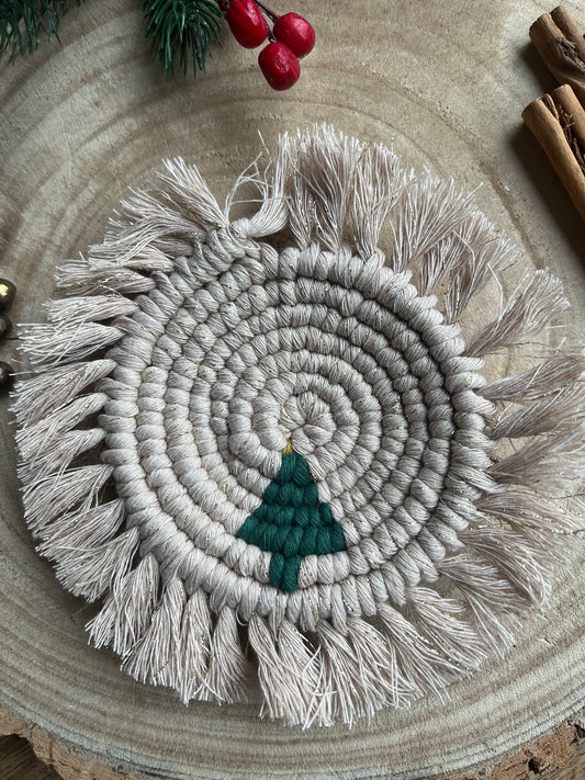 Round macrame coaster with a small christmas tree accent and fringed edge. Handmade with recycled cotton yarn.