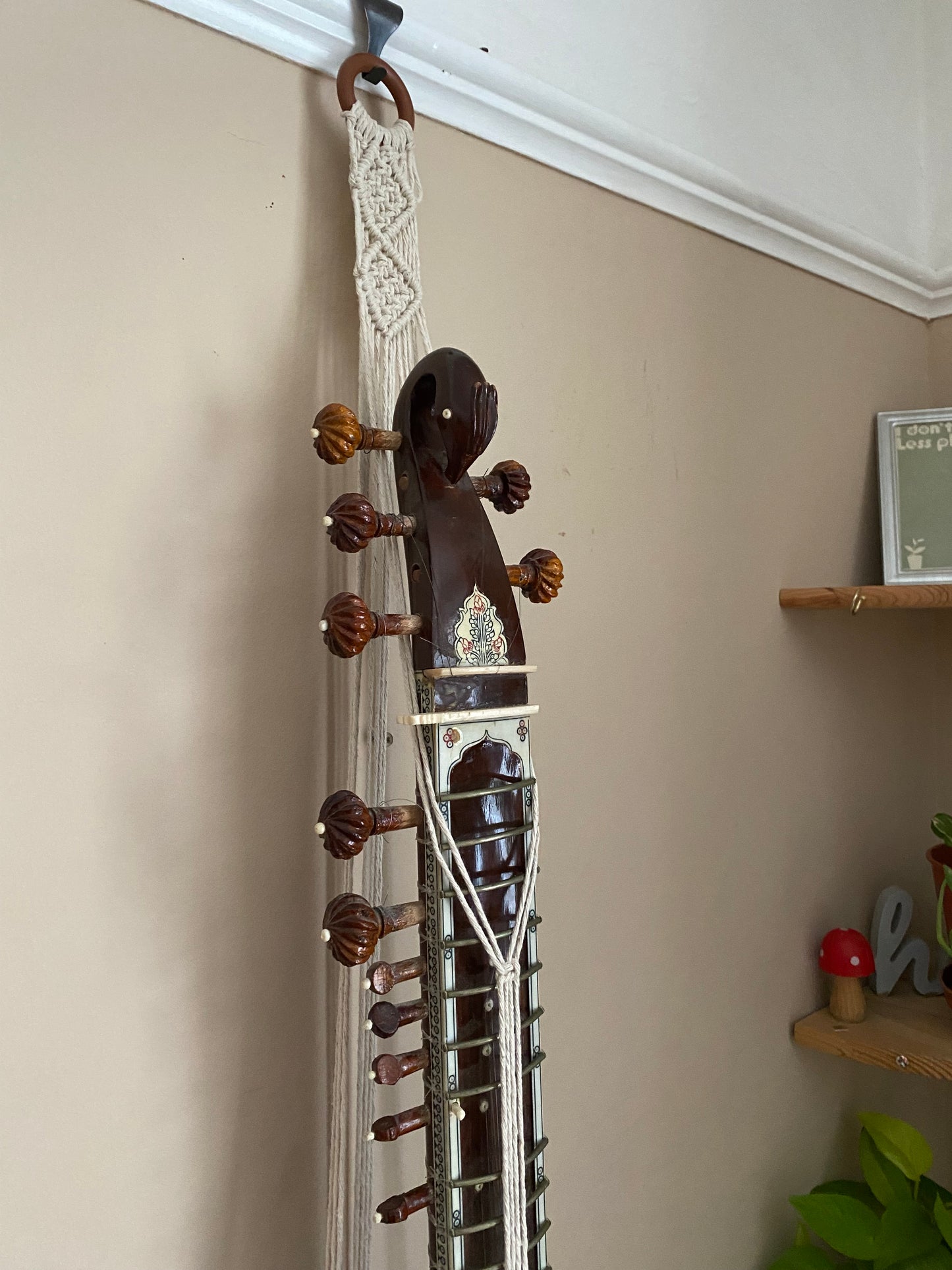 Mini sitar instrument wall hanger. Handmade using natural recycled cotton on a repurposed wooden hanging ring.