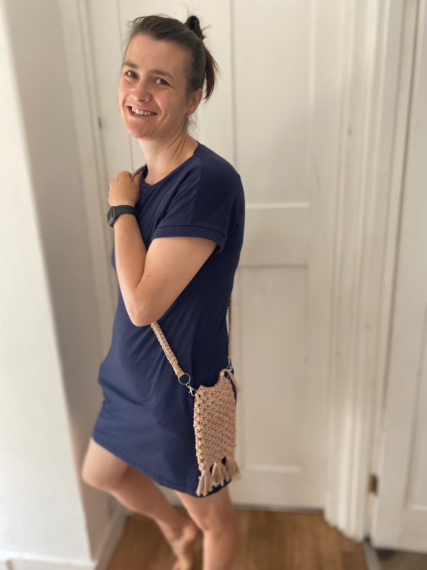 Macra-Made With Love phone bag rainbow being worn inside smiling