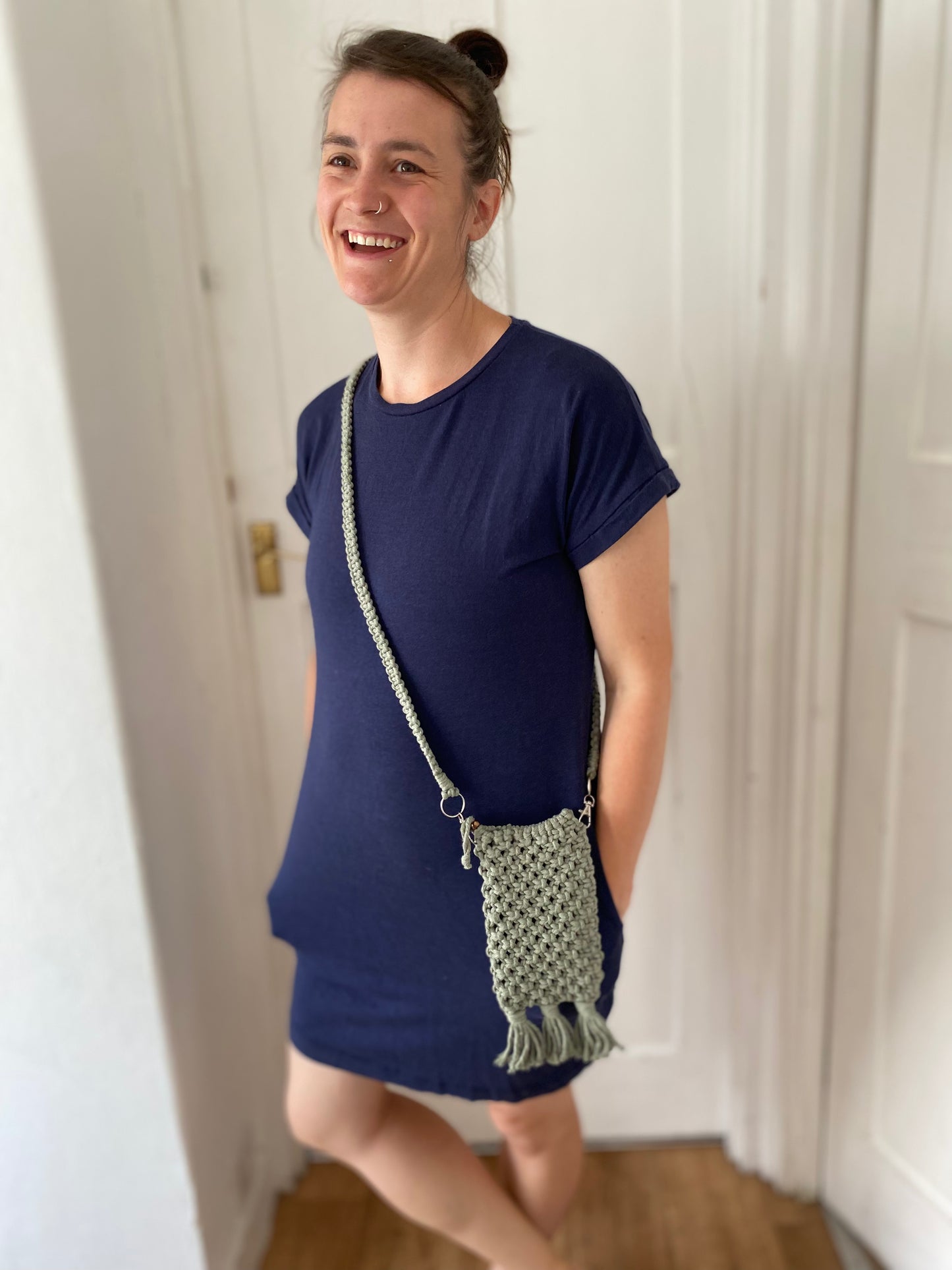 Macra-Made With Love phone bag sage being worn inside laughing