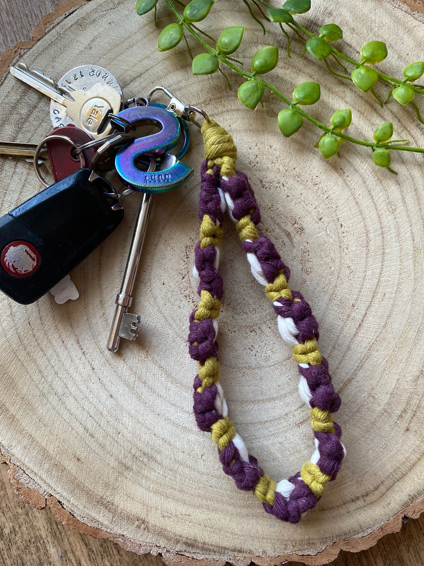 Purple floral wristlet handmade using eco friendly recycled cotton