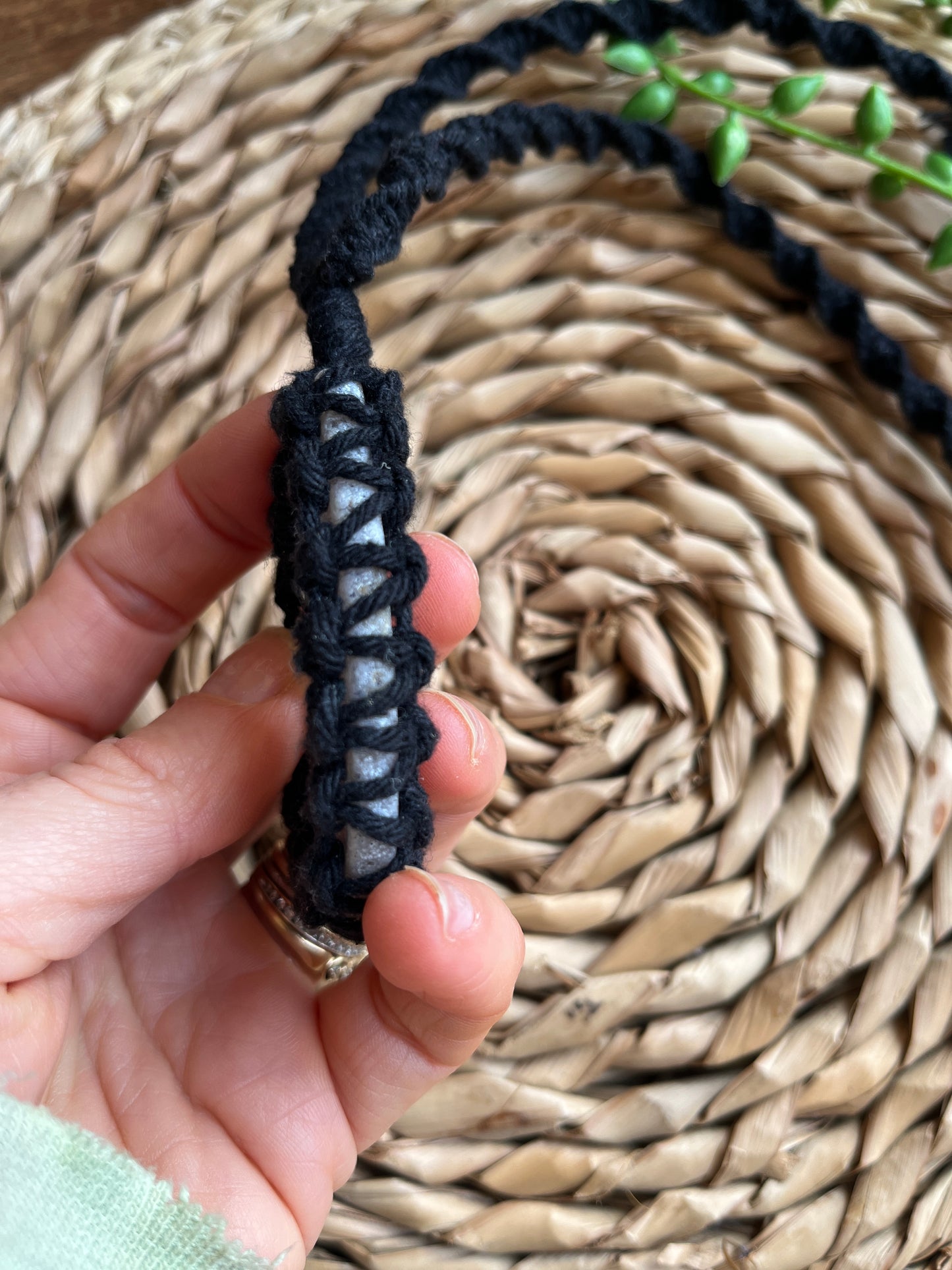 Side of agate slice wrapped in black cord 