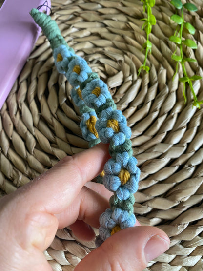 Macra-Made With Love daisy chain phone wrist strap blue knots in hand