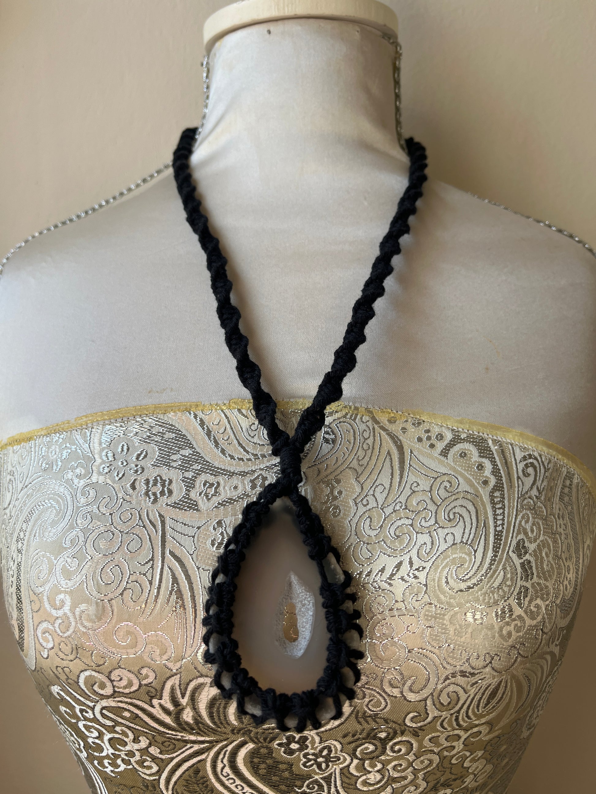 Black necklace with natural agate slice on a mannequin 