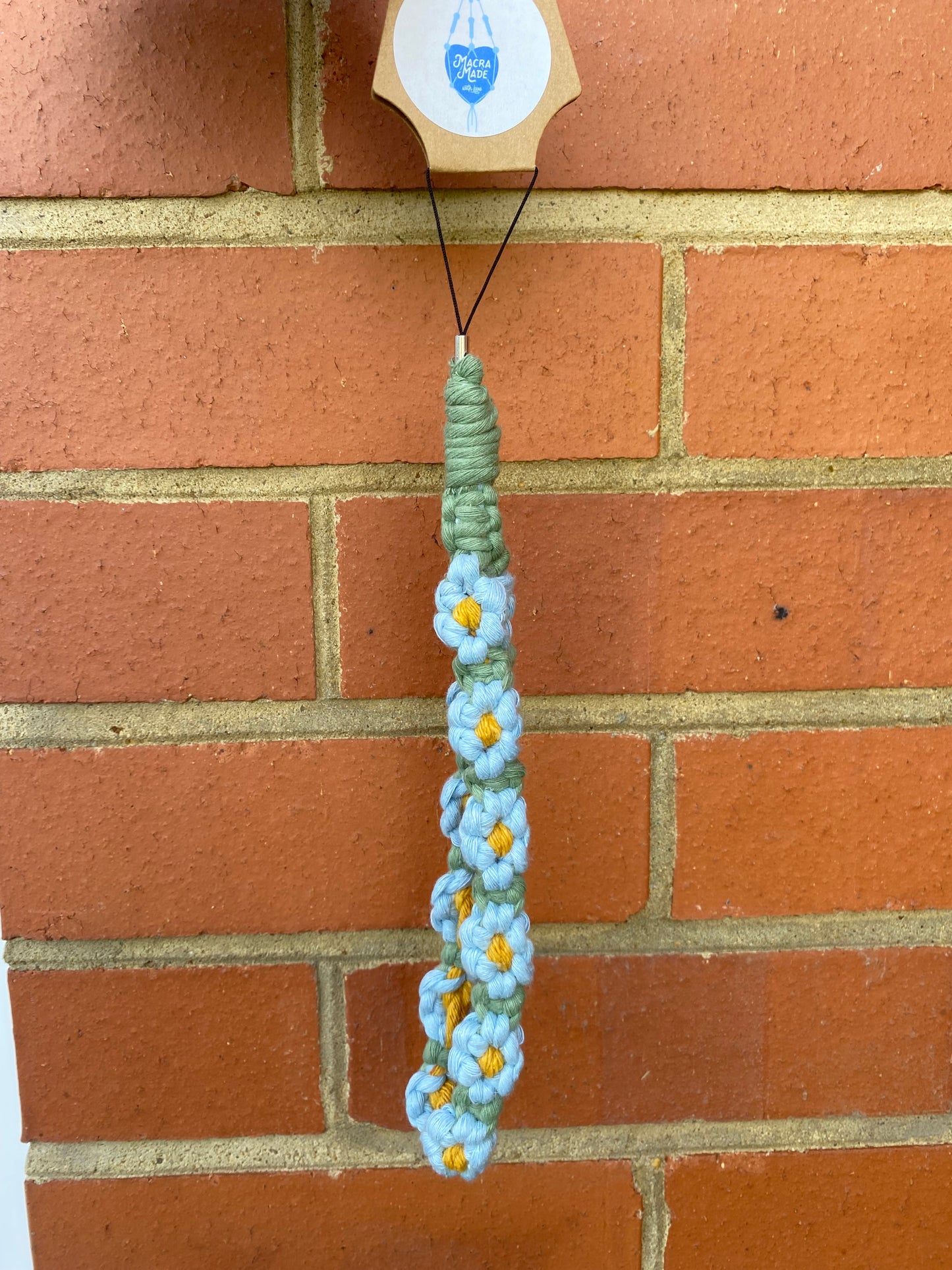 Macra-Made With Love daisy chain phone wrist strap blue on card outside