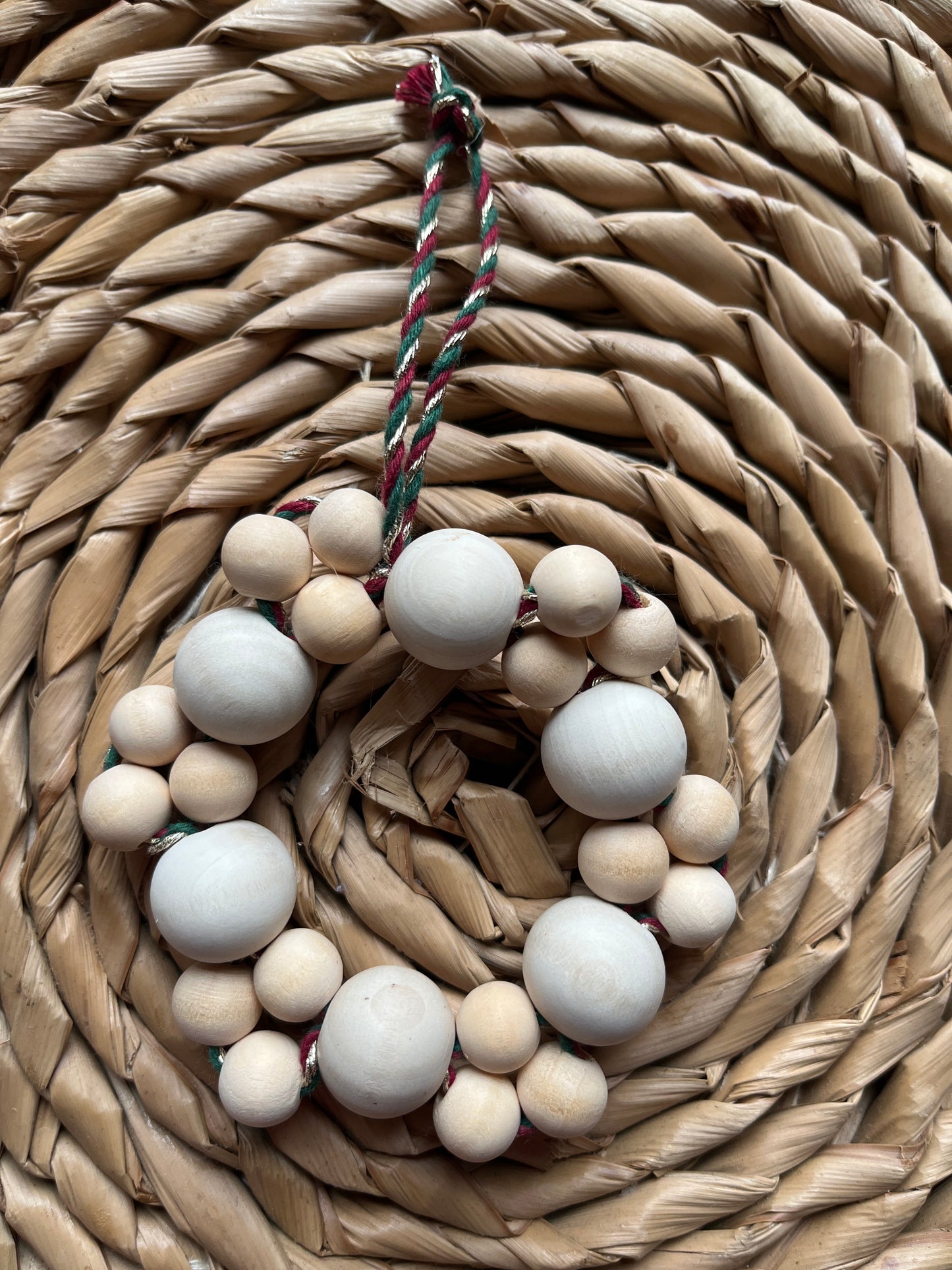 String of brown beads on a woven mat