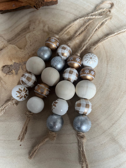 Decorative beads with festive patterns on a beige wooden background