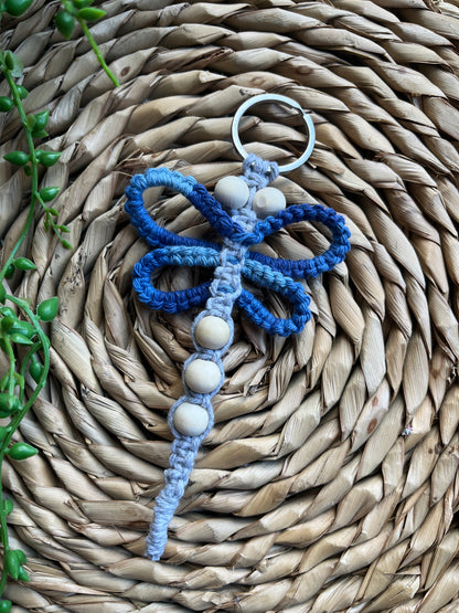 Handmade macrame dragonfly keyring or bag charm, made using shades of blue recycled cotton, on a metal split ring, with small wooden beads. 