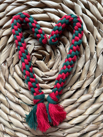 Red and green braided candy canes on a woven surface