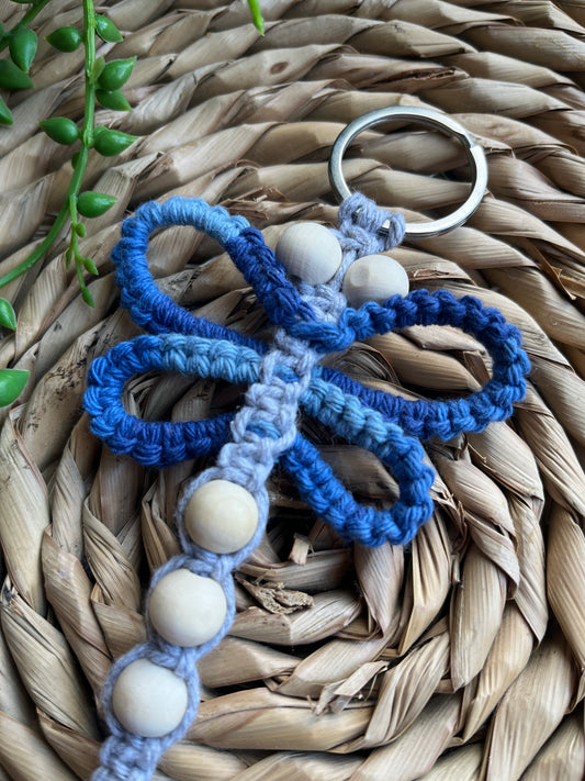 Handmade macrame dragonfly keyring or bag charm, made using shades of blue recycled cotton, on a metal split ring, with small wooden beads. 