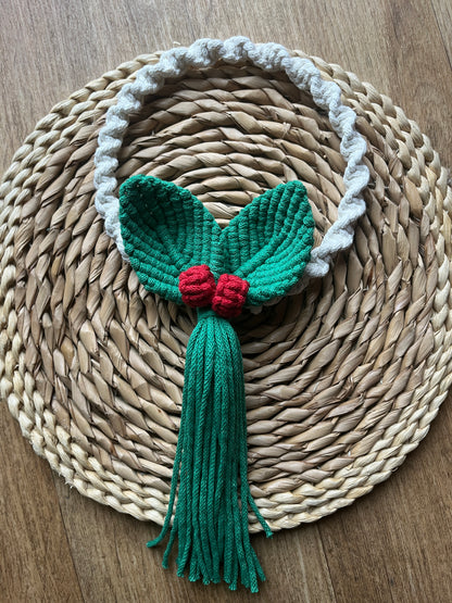 Handmade macrame wreath with green leaves and red berries