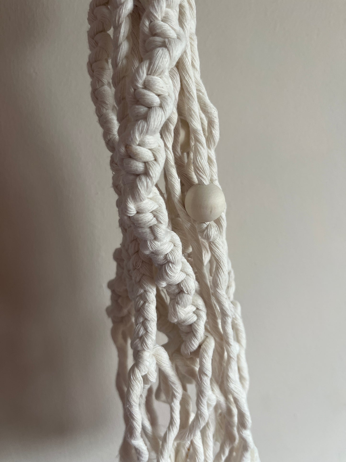 Close-up of braided white rope on a light gray background