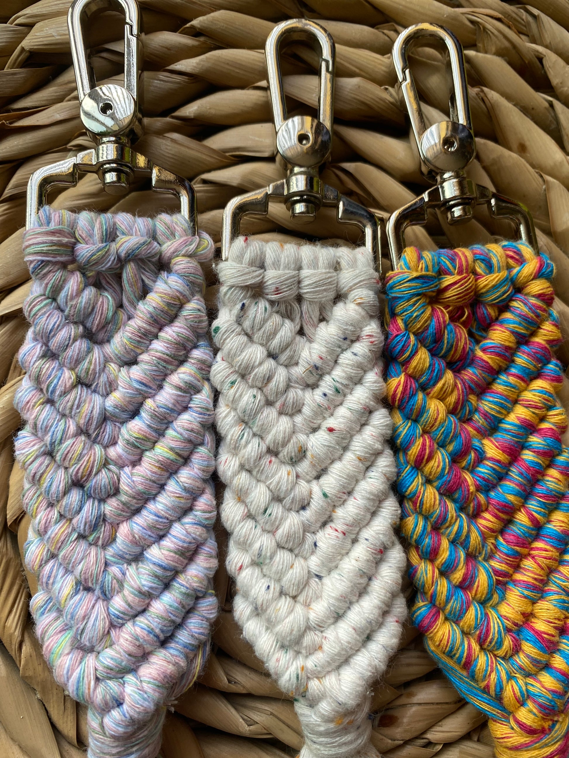 Three handmade macrame keyring, knotted using recycled cotton, in the shape of a mermaids tail, and finished with a metal lobster clasp. 
