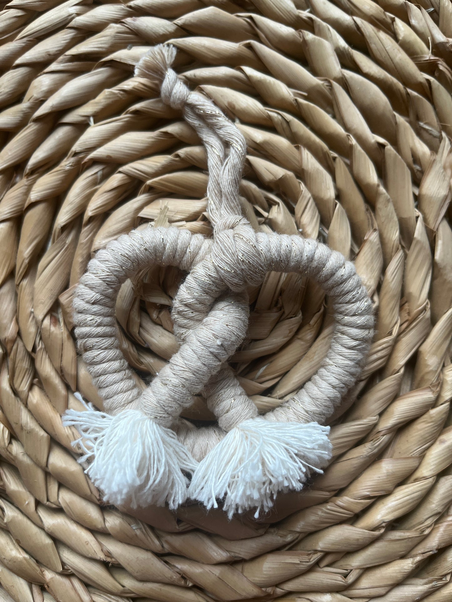 Beige rope pretzel on a woven surface 