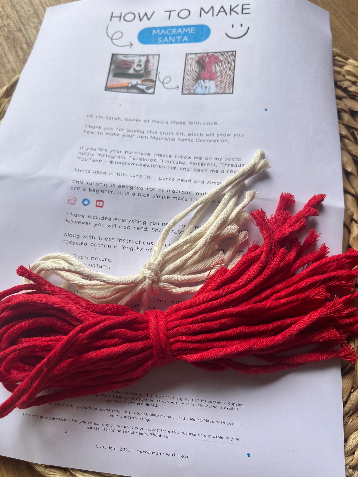 Red and white macrame yarn on a printed DIY craft kit instruction sheet with text and images.