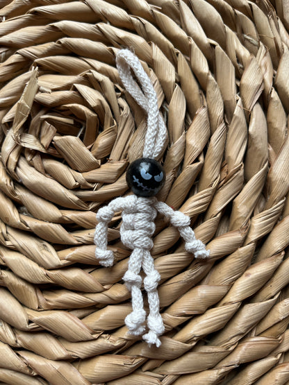 Macrame skeleton made with natural yarn and a black bead