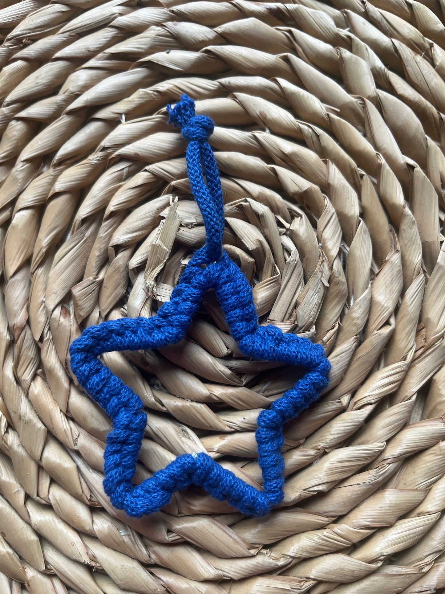 Small blue star decoration on a woven mat