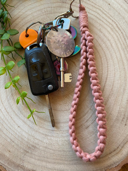 Handmade macrame wristlet keychain with metal clasp, made with blush pink recycled cotton. Shown attached to a small set of keys. 