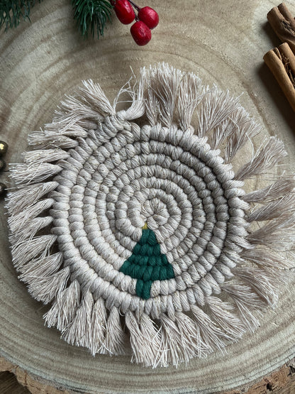 Round macrame coaster with a small christmas tree accent and fringed edge. Handmade with recycled cotton yarn. 
