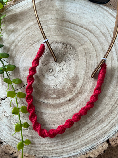 Handmade eyewear strap made with red recycled cotton yarn.