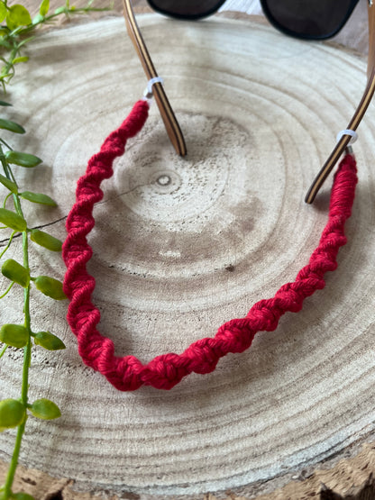 Handmade glasses chain made with red recycled cotton.