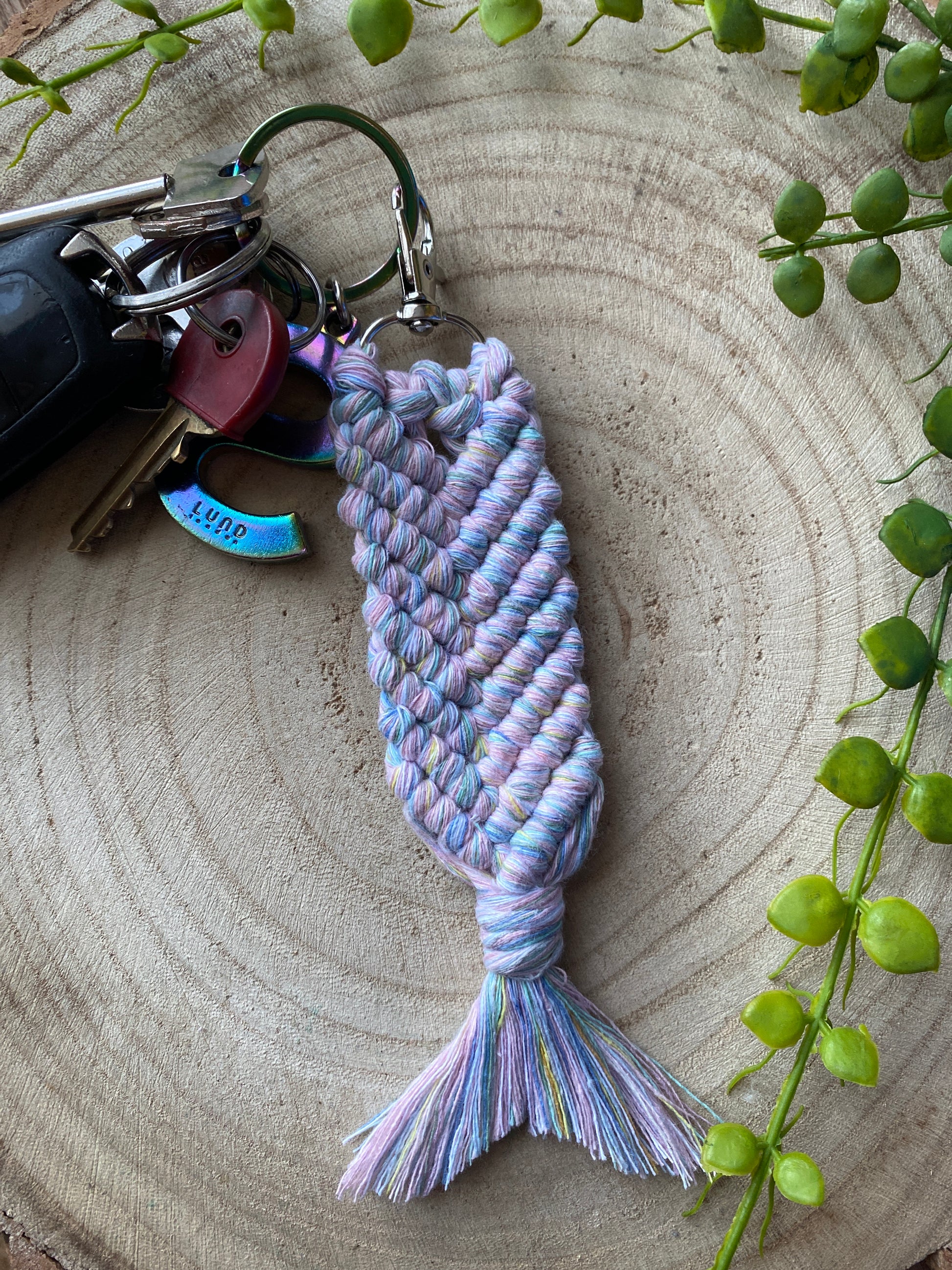 Macra-Made With Love mermaid tail macrame keychain handmade using a soft pastel recycled cotton, attached to a set of car keys using a metal lobster clasp. 